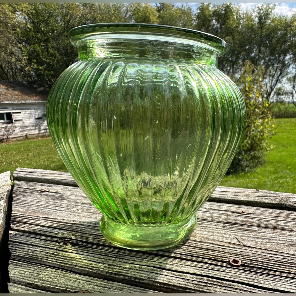 Green glass vase with vertical ribbed texture